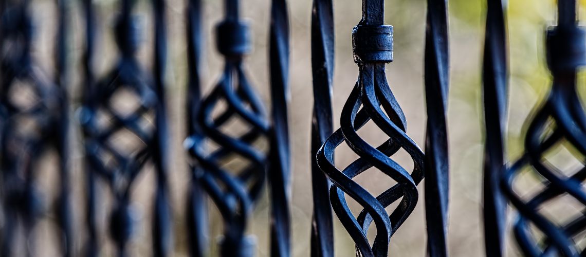 A close-up shot of an ornate wrought iron fence