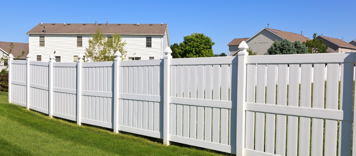 crisp white vinyl privacy fence with decorative pointed post caps
