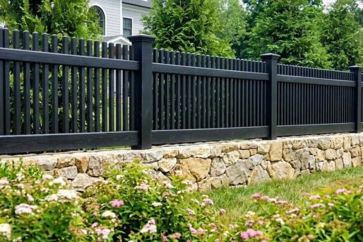 A modern black picket fence installed
